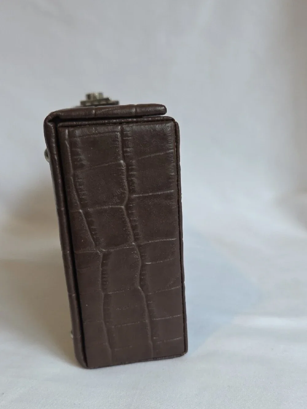 A brown crocodile-embossed faux leather jewelry and watch display box
